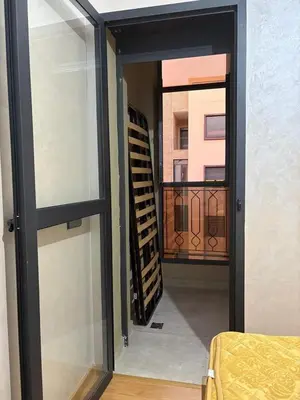 a view of a balcony from a room with a window at cozy and warm apartment in Marrakech
