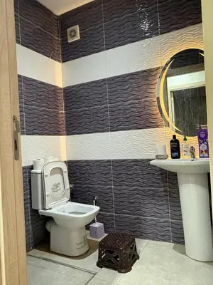 a bathroom with a toilet and a sink at cozy and warm apartment in Marrakech