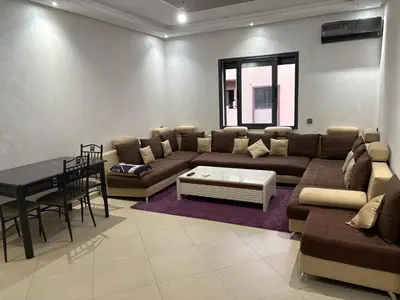 a living room with a couch and a table at cozy and warm apartment in Marrakech