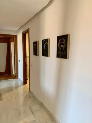 a hallway with four pictures on a wall at Top Floor Apartment with terrace and pool in Marrakech
