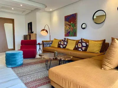 a living room with a couch and a table at Top Floor Apartment with terrace and pool in Marrakech