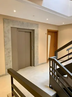 a room with stairs and a door in a building at Top Floor Apartment with terrace and pool in Marrakech