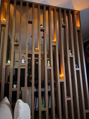 a wooden partition with a table in a room at Cosy Studio Cinema PS5 and home cinema 10 min Downtown in Marrakech