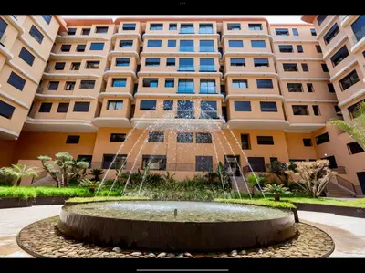a water fountain in front of a building at Cosy Studio Cinema PS5 and home cinema 10 min Downtown in Marrakech