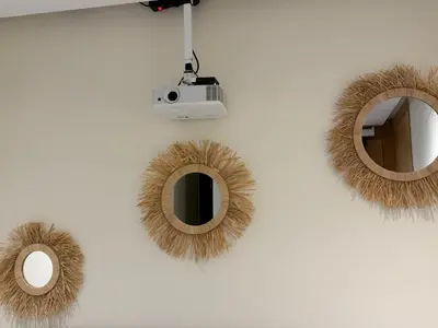 a wall with two mirrors and a camera on it at Cosy Studio Cinema PS5 and home cinema 10 min Downtown in Marrakech