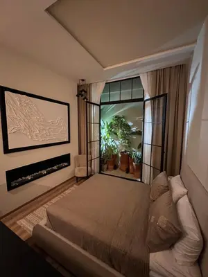 a bedroom with a bed and a large window at studio à marrakech in Marrakech