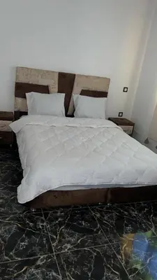 a bedroom with a large bed with white sheets at Spacious and comfortable villa in Marrakech
