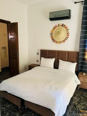 a bedroom with a bed with a wreath on the wall at Spacious and comfortable villa in Marrakech