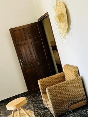 a chair and a stool in front of a door at Spacious and comfortable villa in Marrakech