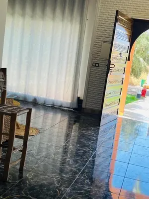 a room with a table and a door with a sign at Spacious and comfortable villa in Marrakech