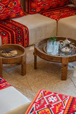 a living room with two tables and two couches at Villa Cõrdõba piscine chauffée et sans vis-à-vis in Marrakech
