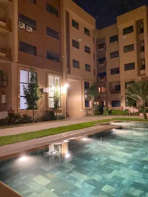 a swimming pool in front of a building at night at Refined stay with 4 pools in Marrakech in Marrakech
