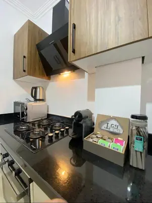 a kitchen with a stove and a box on the counter at Refined stay with 4 pools in Marrakech in Marrakech