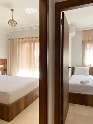 a bedroom with two beds and a window at Refined stay with 4 pools in Marrakech in Marrakech
