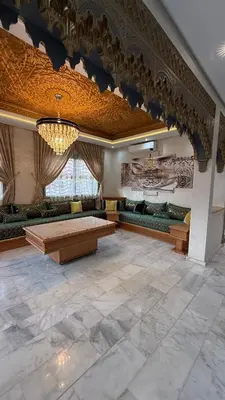 a large room with couches and a table and a chandelier at Villa Targa Marrakech in Marrakech