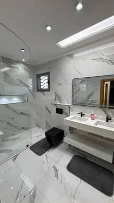 a bathroom with a sink and a shower and a mirror at Villa Targa Marrakech in Marrakech
