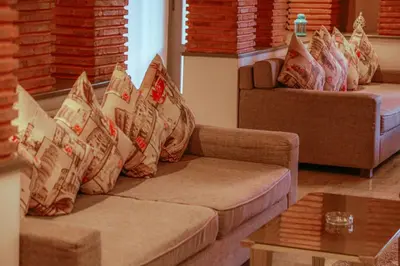 a living room with a couch with pillows on it at Palais Soufi 8 chambres in Marrakech