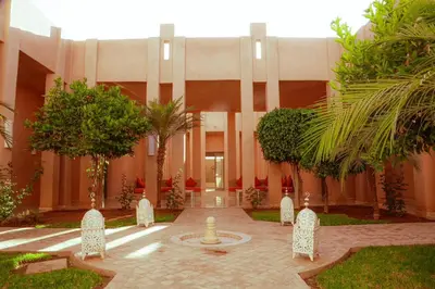 a courtyard with a fountain in the middle of a building at Palais Soufi 8 chambres in Marrakech