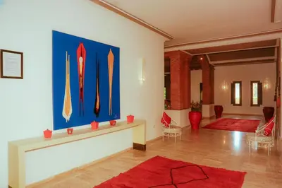 a room with a painting of kayaks on the wall at Palais Soufi 8 chambres in Marrakech