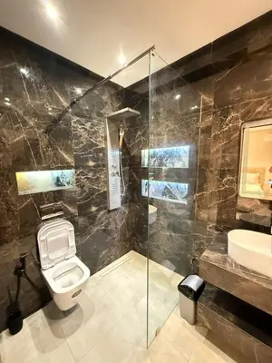 a bathroom with a toilet and a sink and a shower at Marrakech guliz location vacances in Marrakech