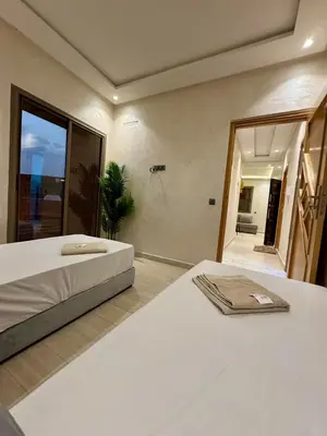 a bedroom with two beds and a large window at Yumo - Cozy 3 in Marrakech