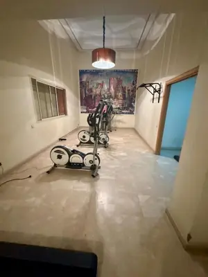 a room with a treadmill in the middle of a room at Elegant 2BR, Pool & Gym Access in Marrakech