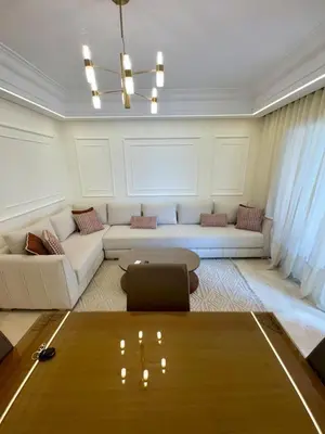 a living room with a couch and a table at Elegant 2BR, Pool & Gym Access in Marrakech