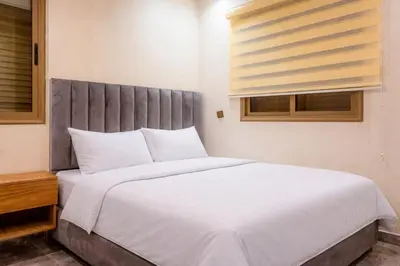 a bedroom with a large white bed and a window at 2 bedrooms abouab gueliz in Marrakech