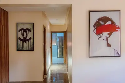 a hallway with two pictures of a woman on the wall at 2 bedrooms abouab gueliz in Marrakech