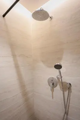 a shower with a shower head in a bathroom at Palmier d'or - Marrakech Centre in Marrakech