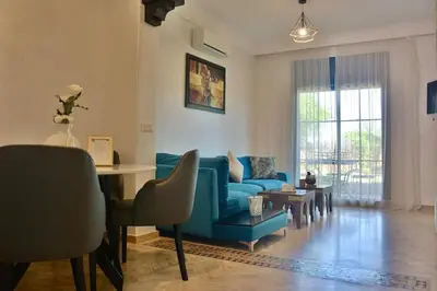 a living room with a blue couch and a table at Marrakxi in Marrakech