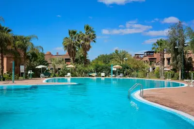 a swimming pool at a resort with blue water at Marrakxi in Marrakech