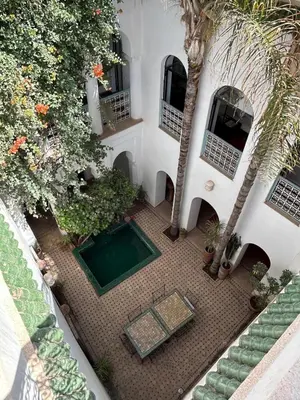 an overhead view of a courtyard with a pool in a building at Luxury riad breakfast included in Marrakech