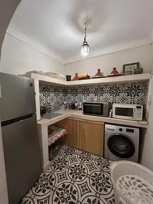 a kitchen with a washer and a microwave at Luxury riad breakfast included in Marrakech