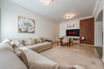 a living room with a couch and a table at Cosy Palace elevator and pool in Marrakech