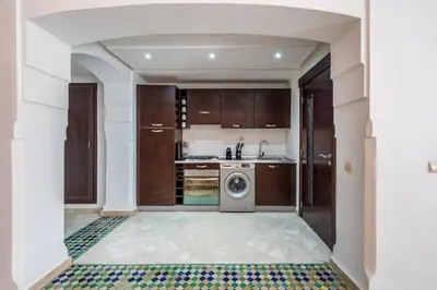 a kitchen with a washer and dryer in a room at Cosy Palace elevator and pool in Marrakech