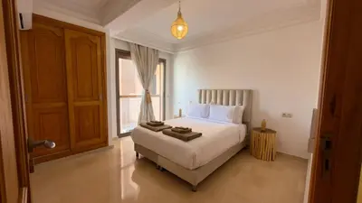 a bedroom with a bed and a large window at L'Écrin by Louhou Collection - Plein centre in Marrakech