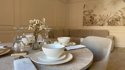 a dining room table with cups and plates on it at L'Écrin by Louhou Collection - Plein centre in Marrakech