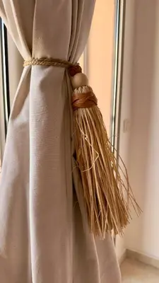 a tied up curtain with a broom on a window at L'Écrin by Louhou Collection - Plein centre in Marrakech