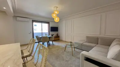 a living room with a couch and a table at L'Écrin by Louhou Collection - Plein centre in Marrakech