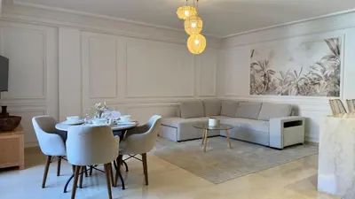 a living room with a couch and a table and chairs at L'Écrin by Louhou Collection - Plein centre in Marrakech