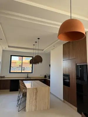 a kitchen with a wooden island in a room at Villa Terracotta Marrakech in Segraga