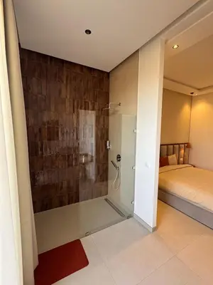 a bathroom with a shower and a bed in a room at Villa Terracotta Marrakech in Segraga
