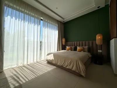 a bedroom with a bed and a large window at Villa Terracotta Marrakech in Segraga