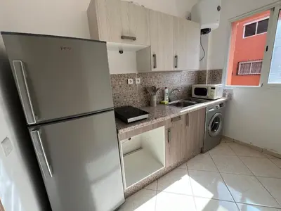 a kitchen with a stainless steel refrigerator and a sink at Khamo Apartment, 15 min Walking to Airport, 15 min by Taxi to Medina in Marrakech