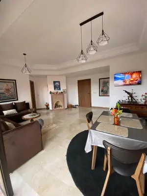 a living room with a table and a couch at Sunny Corner Apartment in Marrakech