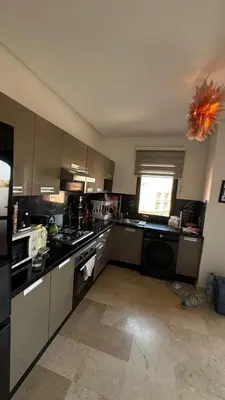a kitchen with stainless steel appliances and a window at Sunny Corner Apartment in Marrakech