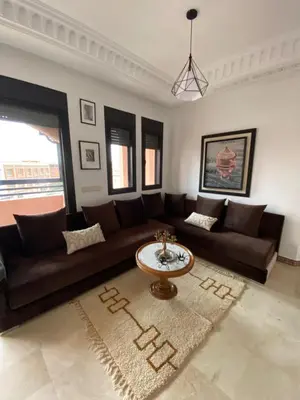 a living room with a couch and a table at Sunny Corner Apartment in Marrakech