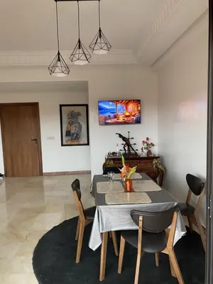 a dining room with a table and chairs at Sunny Corner Apartment in Marrakech