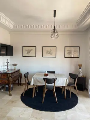 a dining room with a table and chairs at Sunny Corner Apartment in Marrakech